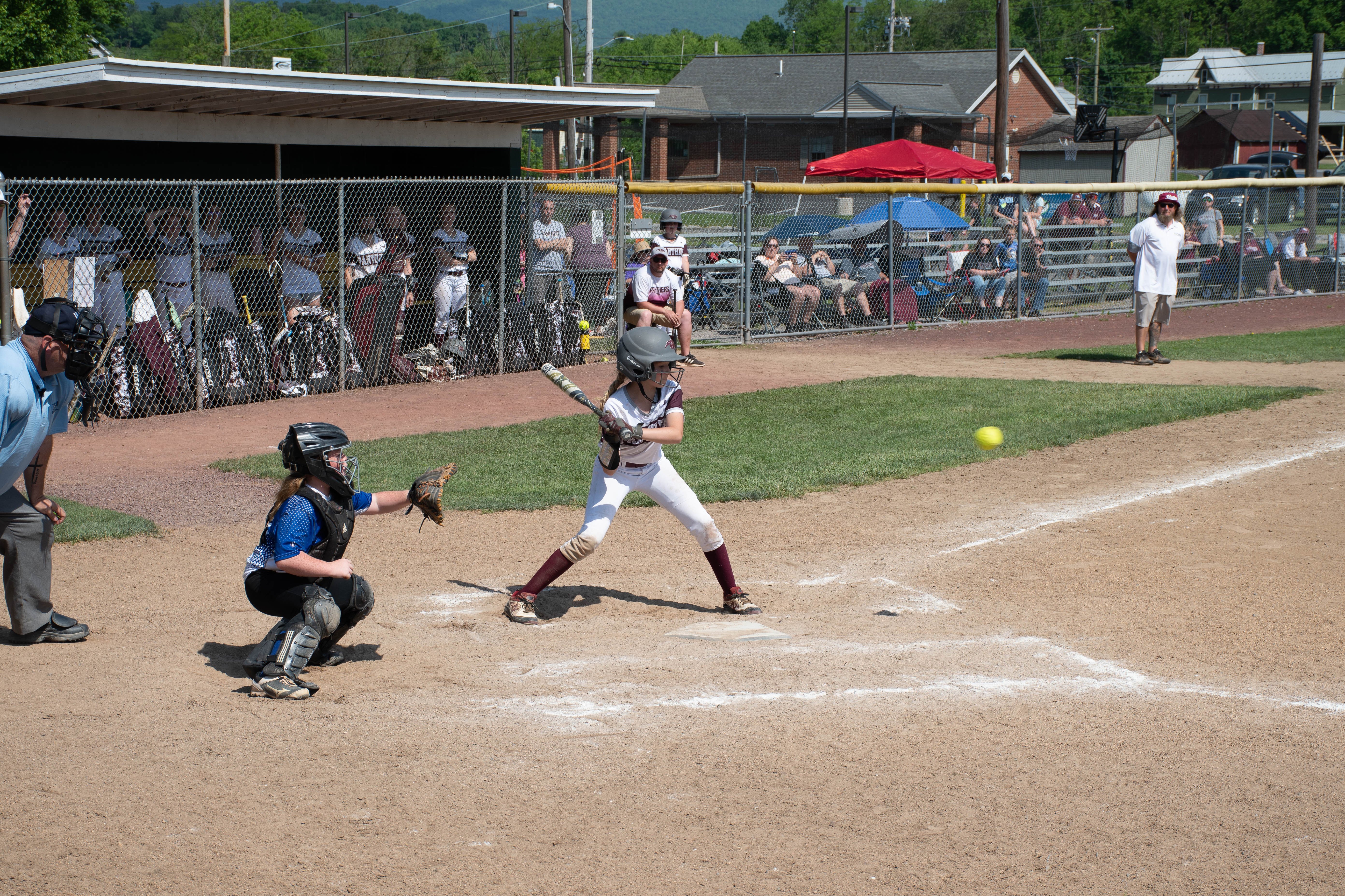 Catcher and batter, who is mid-swing about to hit the ball.